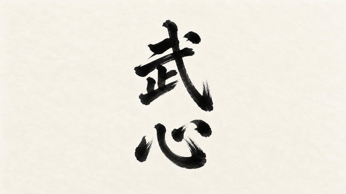 Bushin kanji 武心 in black brush calligraphy on off-white paper, representing martial spirit.