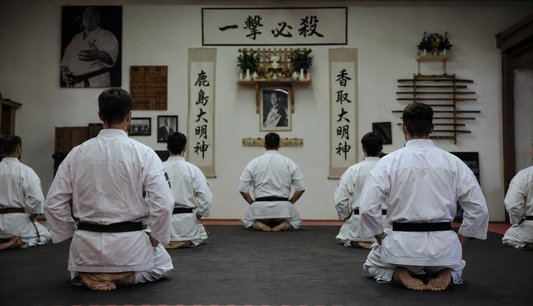 Kyokushin karate practitioners kneeling in seiza during training in a traditional dojo.