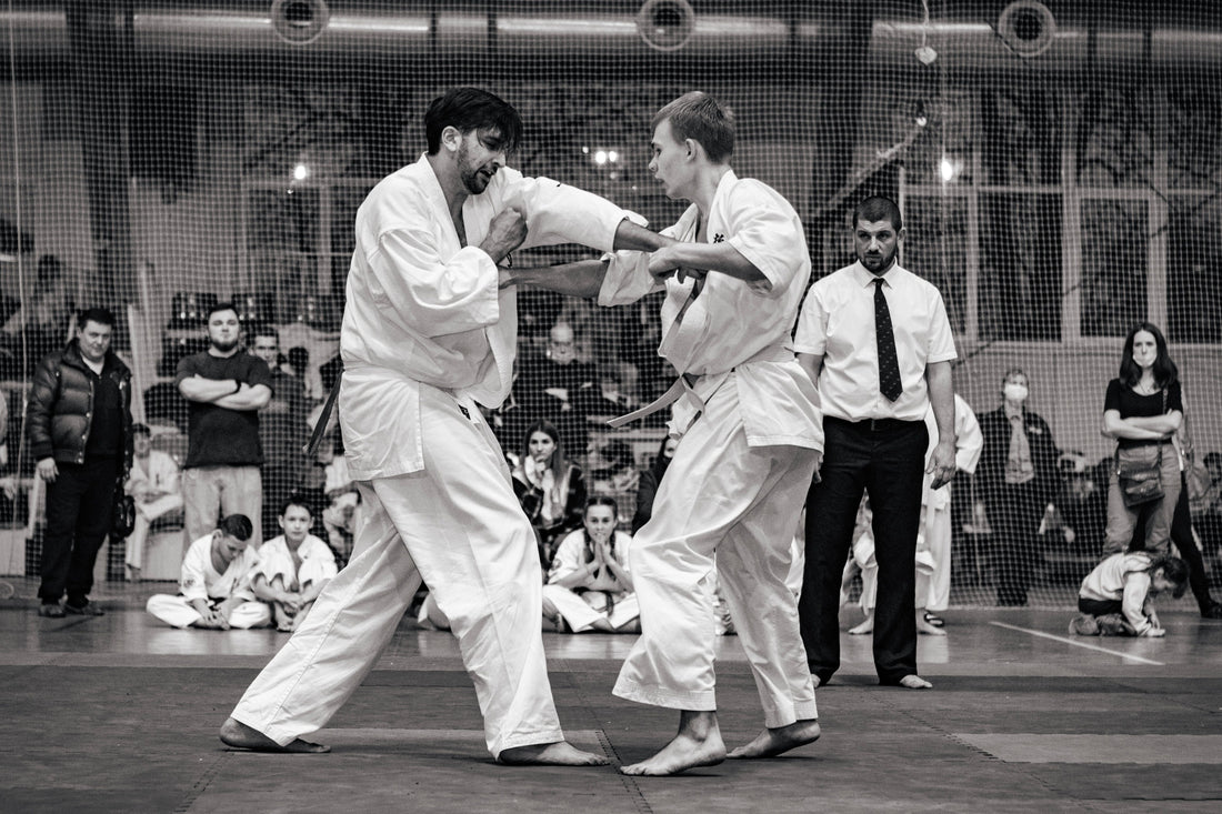 Bare-knuckle karate fighters exchanging body punches during full-contact competition
