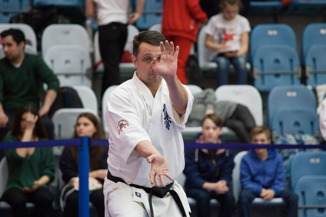 Kyokushin black belt performing kata during a karate competition