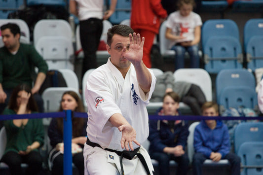 Kyokushin black belt performing kata during a karate competition