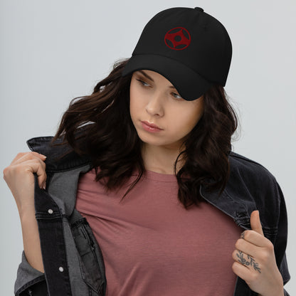Woman wearing a navy blue cap with kanku logo on a gray background