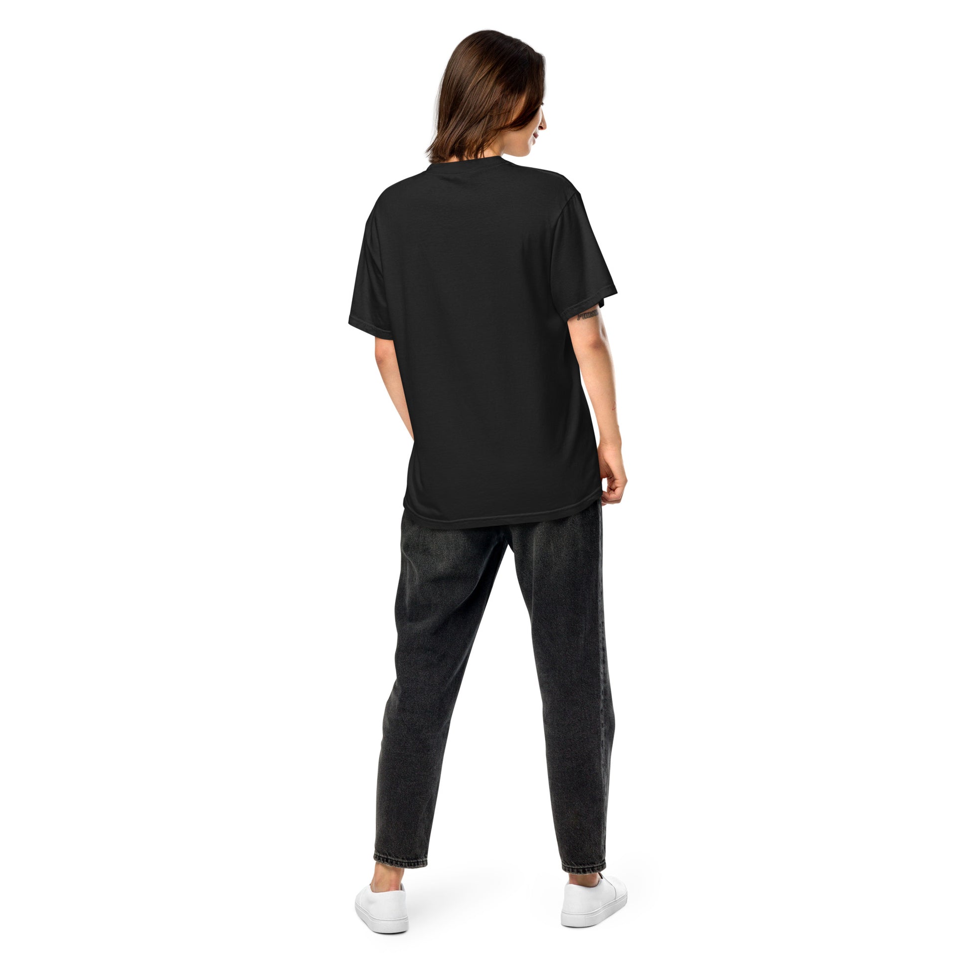 Person wearing a black t-shirt and dark pants on a white background