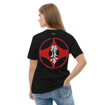 Person wearing a black t-shirt with a gold leaf design on the back, standing against a white background.