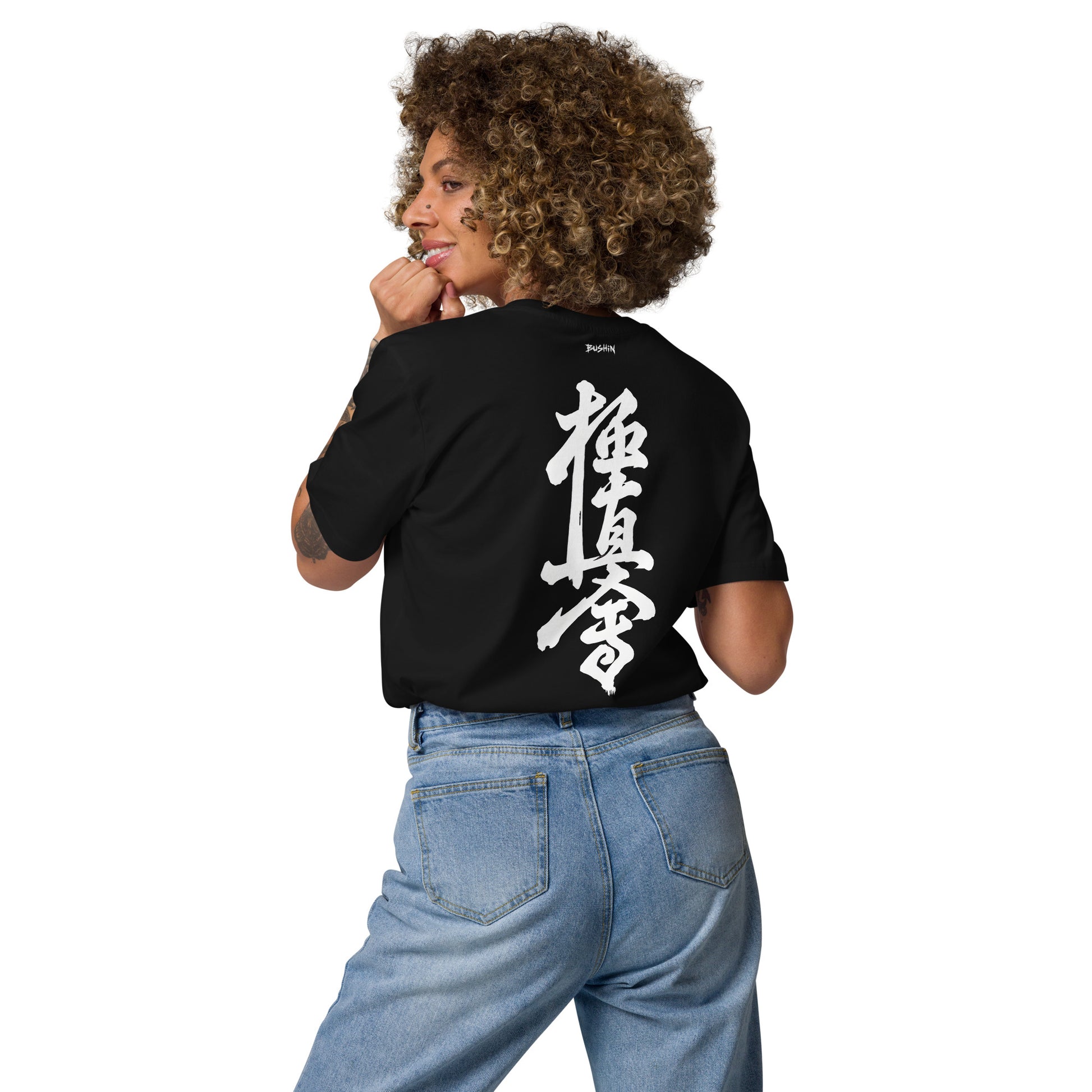 Person wearing a black t-shirt with 'The 2 AM Club' text and graphic on the back.