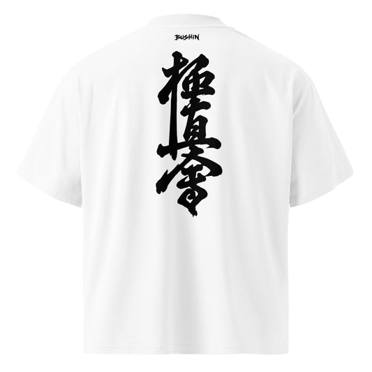 White short-sleeve T-shirt shown from the back, featuring a large black vertical Japanese kyokushin calligraphy graphic on the center back and a small black 'BUSHIN' brand mark printed inside the collar.