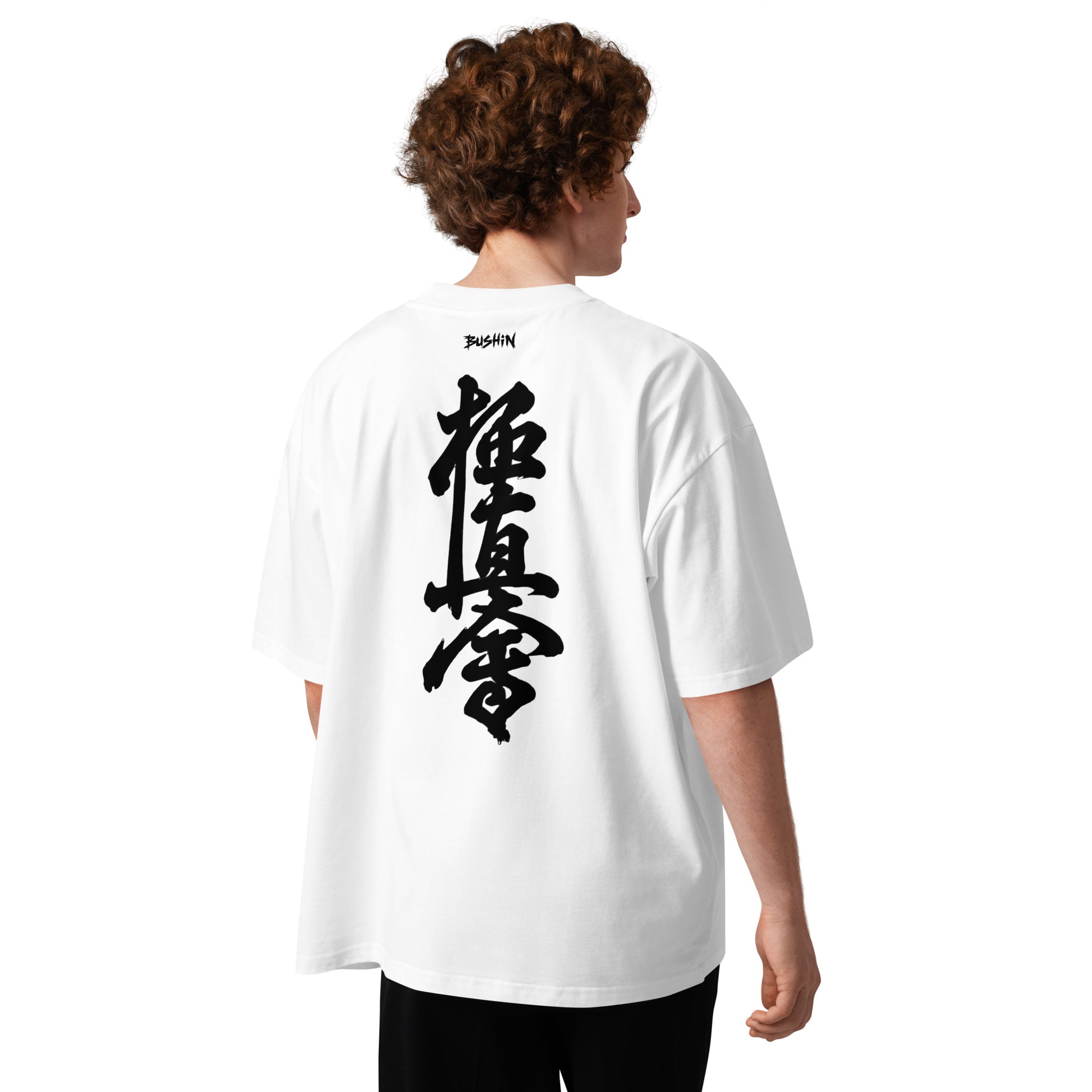 Person wearing a white t-shirt with 'kyokushin' design on the back