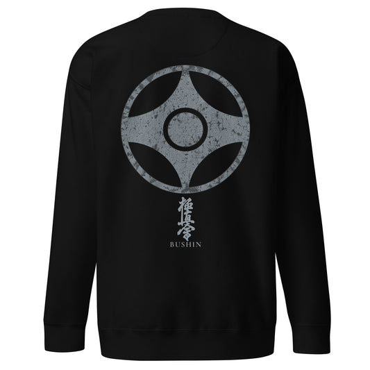 A black crewneck sweatshirt shown from the back, featuring a large distressed gray kanku graphic with Japanese kyokushin kanji and the word 'BUSHIN' printed below it.