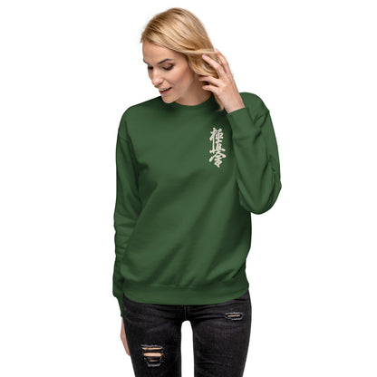 Woman wearing a dark green sweatshirt with a kyokushin logo