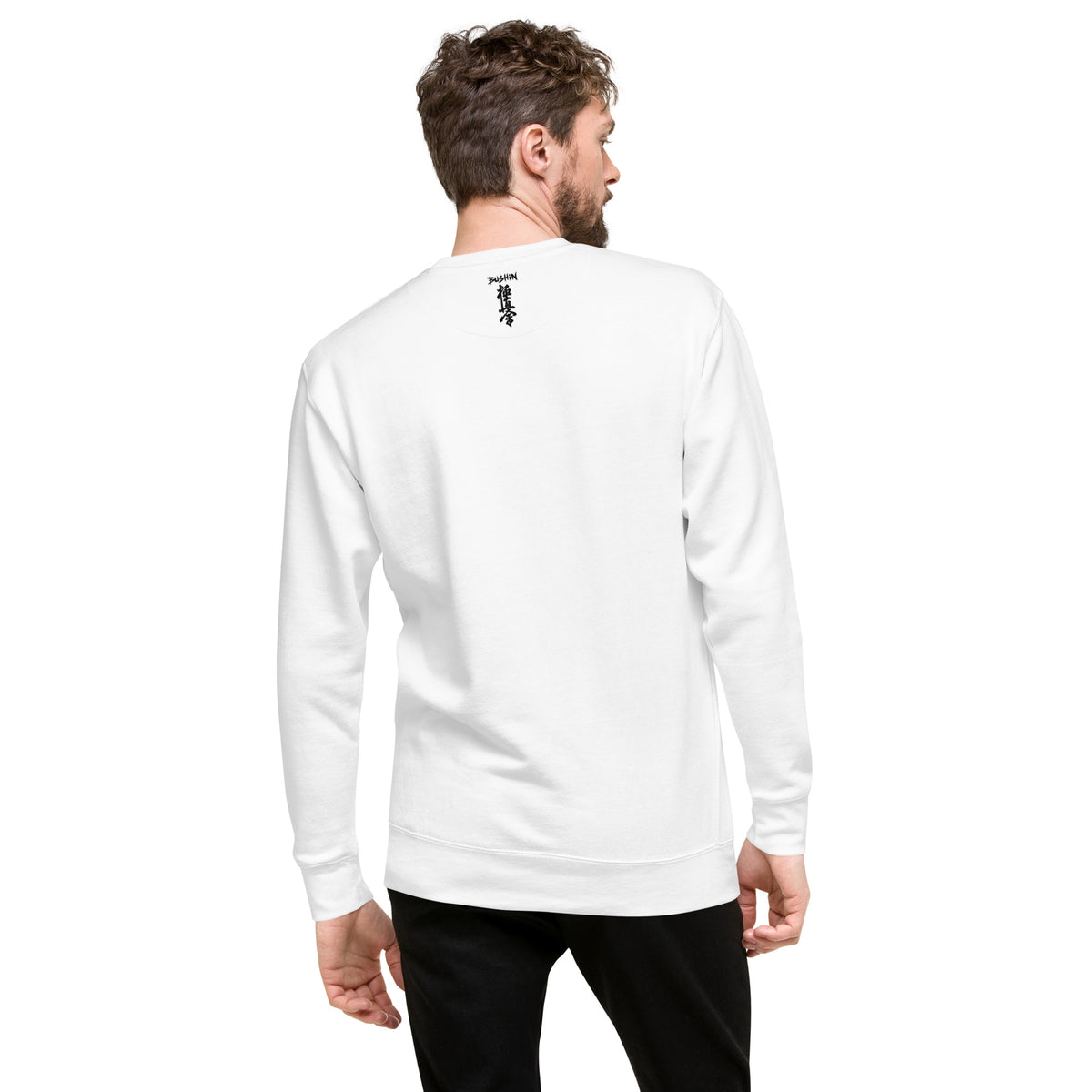 Man wearing a white long-sleeve shirt with logos on the back against a white background