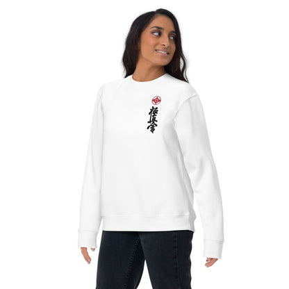 A women wearing white crewneck sweatshirt with a small red kanku logo and black kyokushin calligraphy printed vertically on the left chest, shown against a plain white background. 