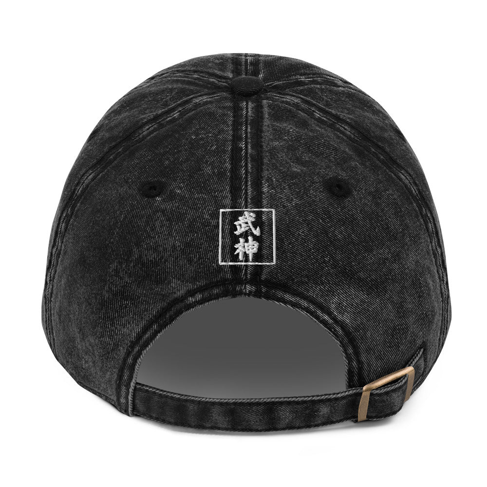 Black denim cap with a logo on the back against a white background