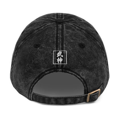 Black denim cap with a logo on the back against a white background